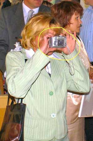woman taking picture with camera round the wrong way