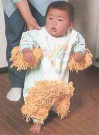 standing baby with mop on babygro
