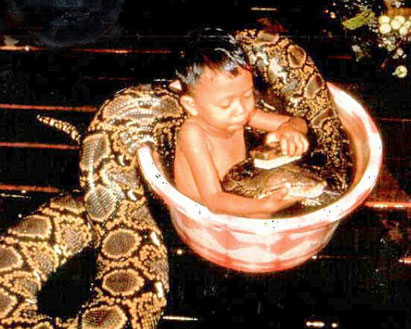 a boy and a snake taking a bath together