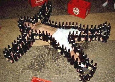 man surrounded by bottles