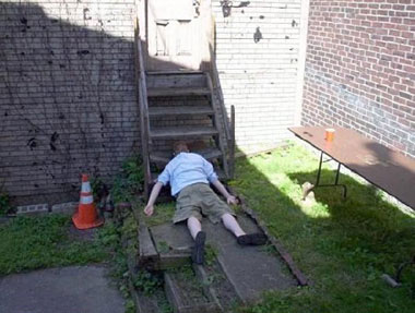 man face down at bottom of steps