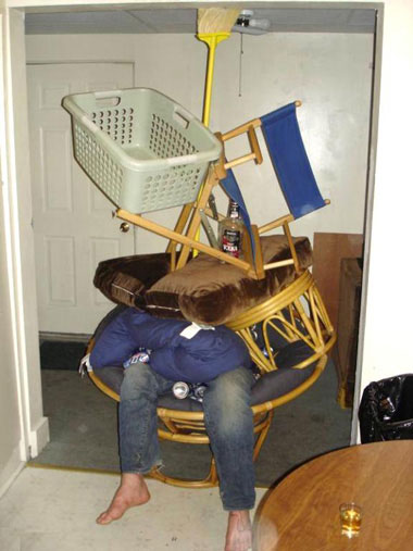man covered in household items