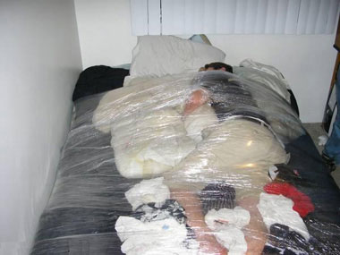 man wrapped in cling film