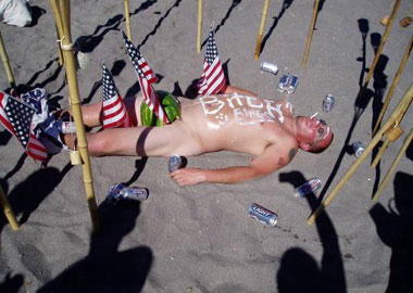 man on beach surround by flags